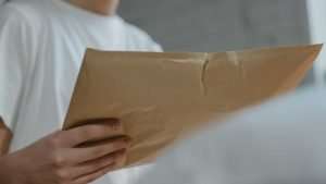 A woman clutching a direct mail piece.